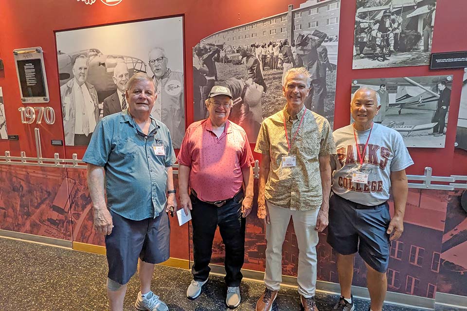 Alpha Pi Sigma Fraternity brothers pose for a photo at a reunion
