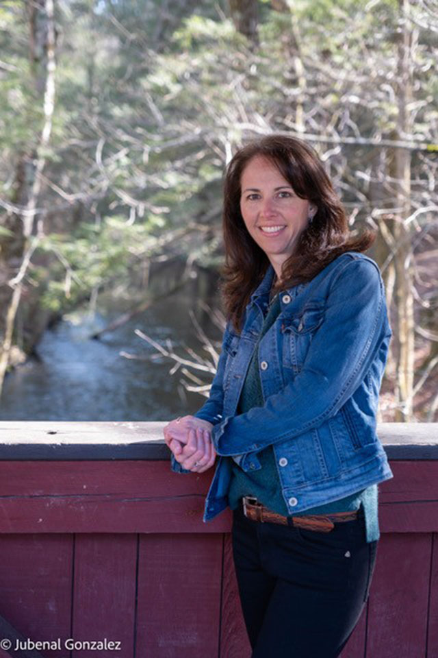 Melissa Marquis A woman poses for a photo against a backdrop.
