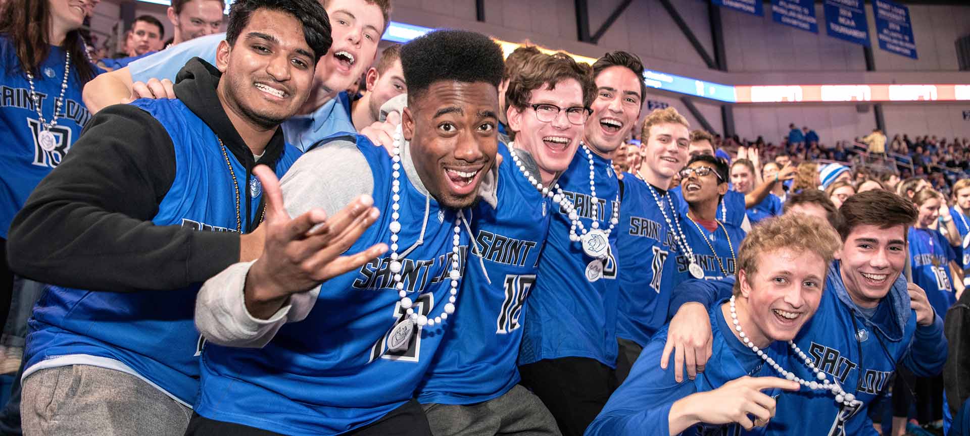 Students with their faces painted in blue at the Billiken blue out game.